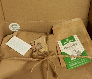 A cardboard box filled with a bag of tea and a card