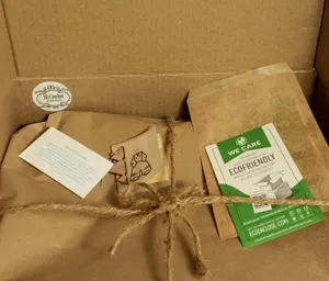 A cardboard box filled with a bag of tea and a card