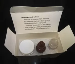 A cardboard box containing three bottles of syrup