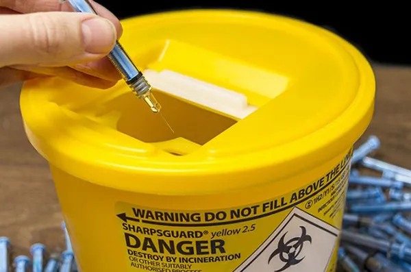 Absorbent pads for sharps bins